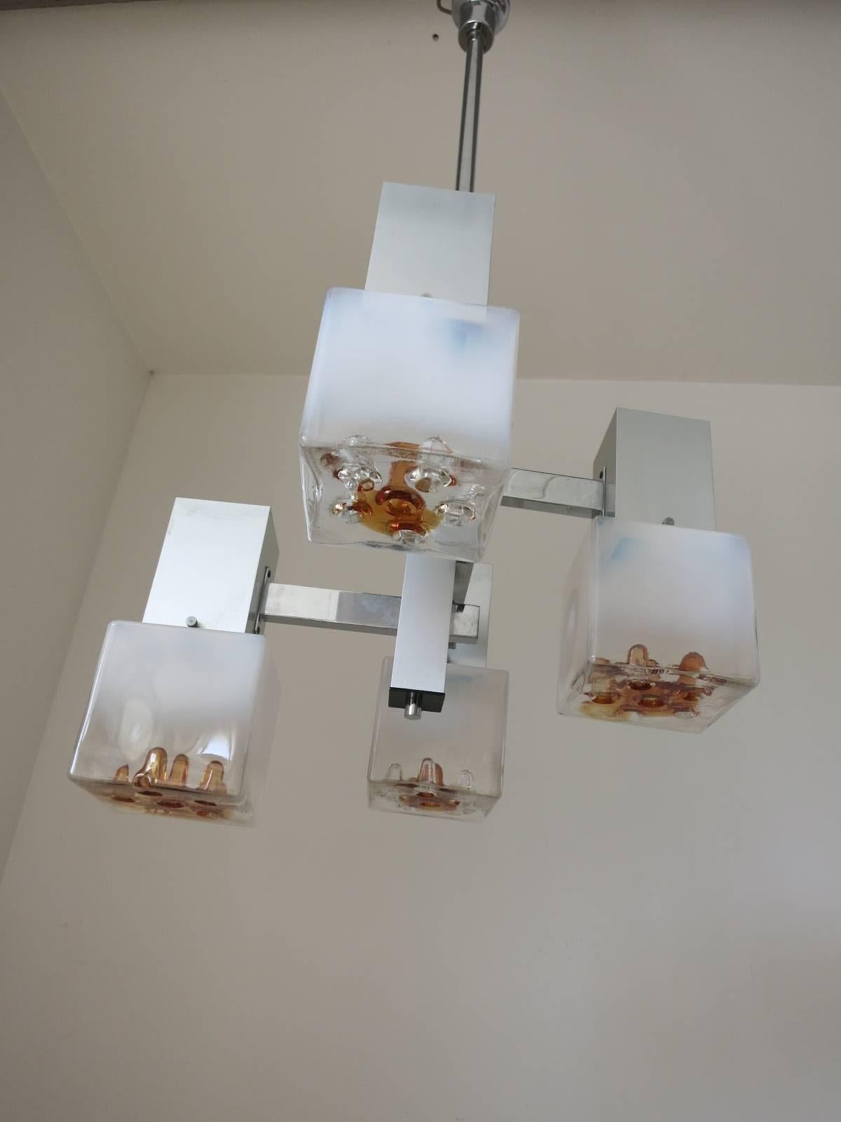 Vintage Italian pendant with lightly frosted Murano glass cubes and infused amber glass details, mounted geometrically on brushed chrome frame / Designed by Mazzega circa 1960’s / Made in Italy
4 lights / E12 or E14 type / max 40W each 
Diameter: 19