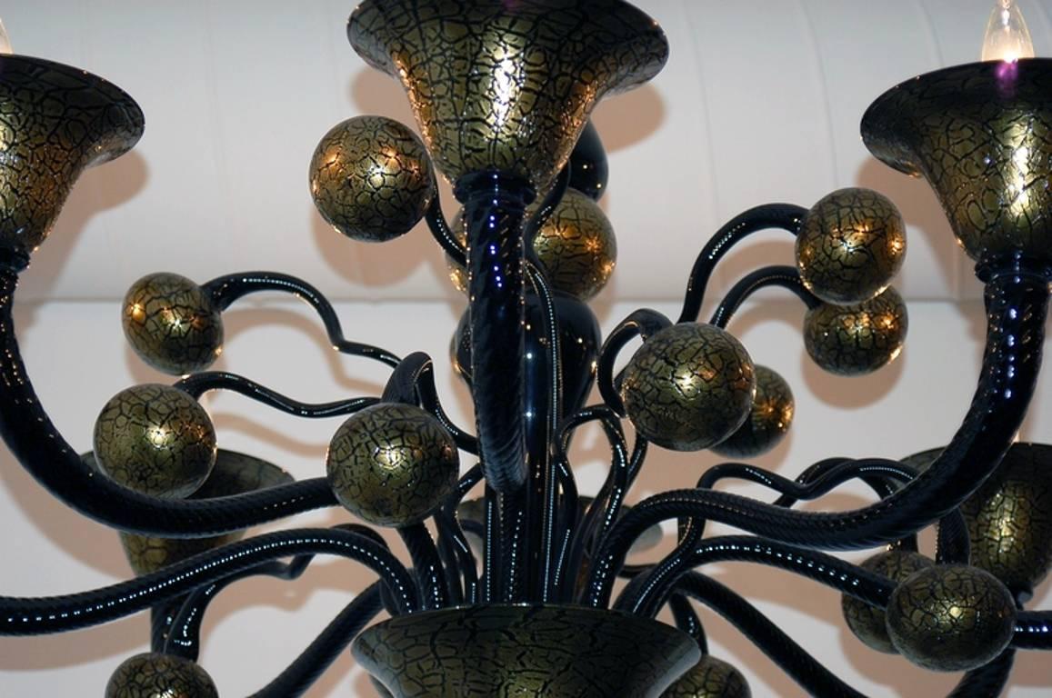 Vintage Italian chandelier with hand blown black and gold Murano glasses / Designed by Signoretto circa 1980’s / Signature of the Maestro on the chandelier / Made in Italy 
8 lights / E12 or E14 type / max 40W each
Diameter: 43 inches / Height: 46