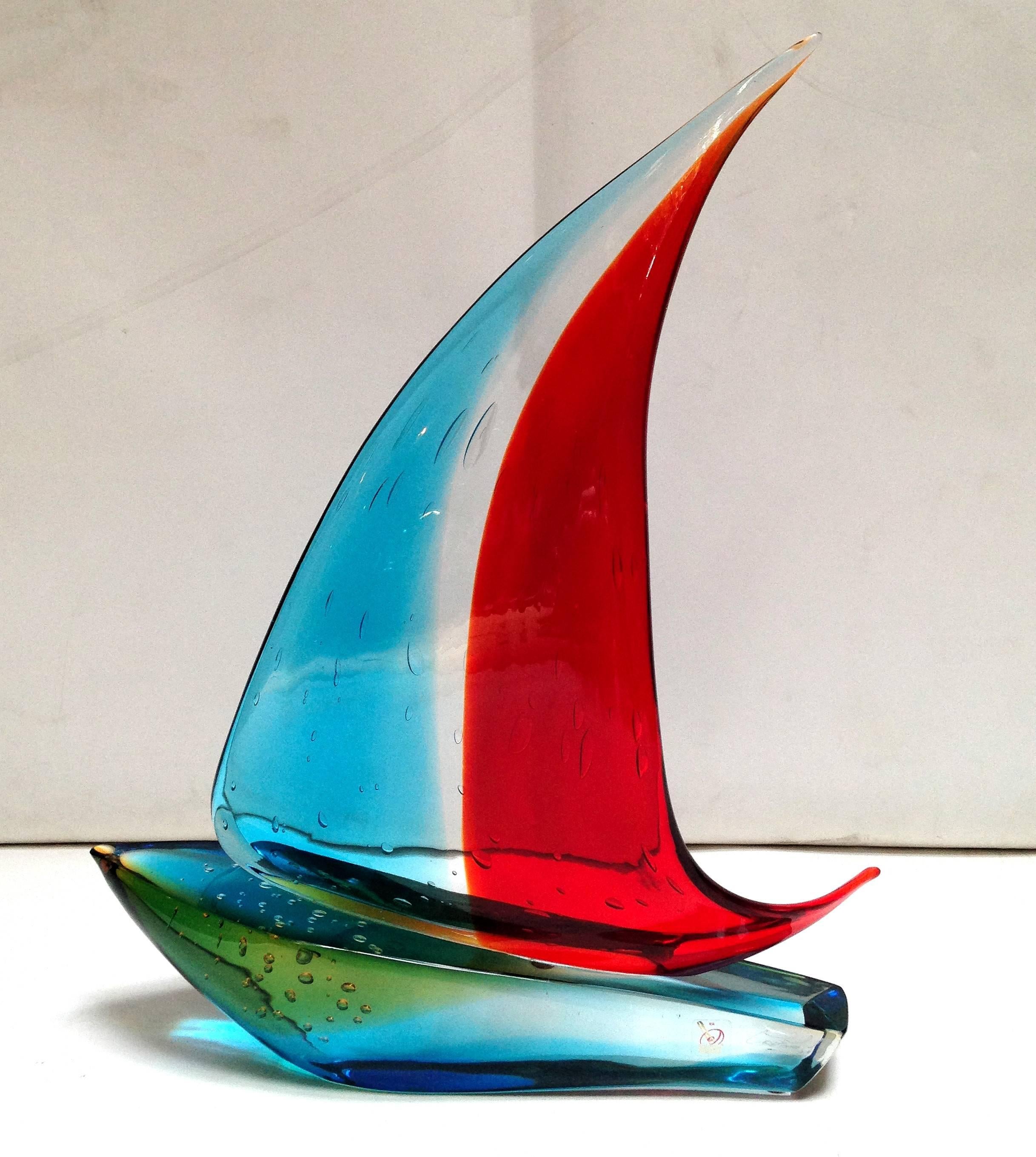 Vintage Italian single sail boat hand blown and crafted in red, blue, and yellow Murano glass by Sergio Constantini
Signed on the base / Made in Italy in the 1960’s 
Height: 19 inches / Width: 14.5 inches / Depth: 4 inches 
1 in stock in Palm