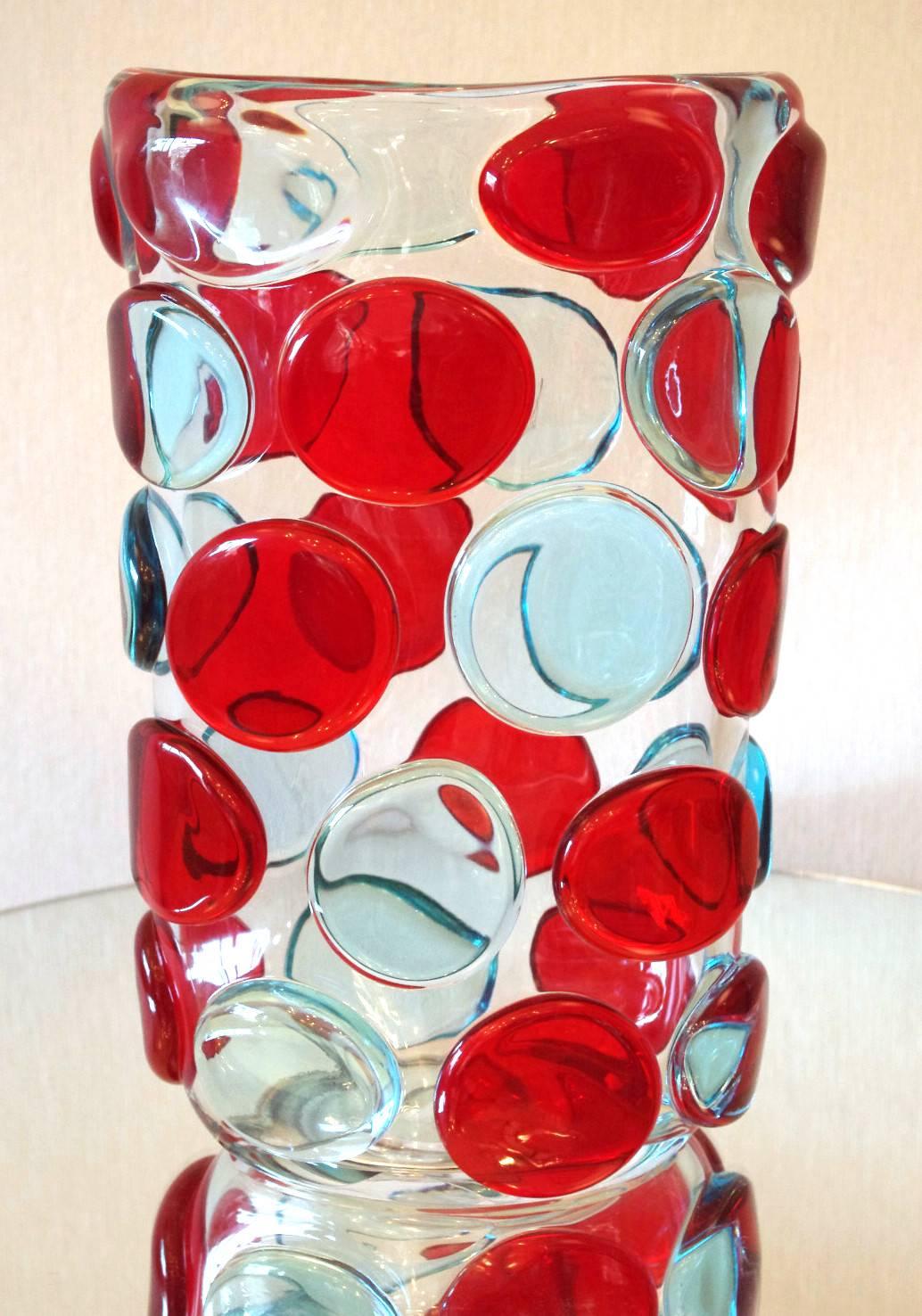 Beautiful vase with clear Murano glass body and decorative red and light blue Murano glass buttons by Camozzo and signed on the base
Made in Italy in the 1970’s
Height: 13.5 inches / Width: 9 inches / Depth: 5.5 inches
1 in stock in Palm Springs