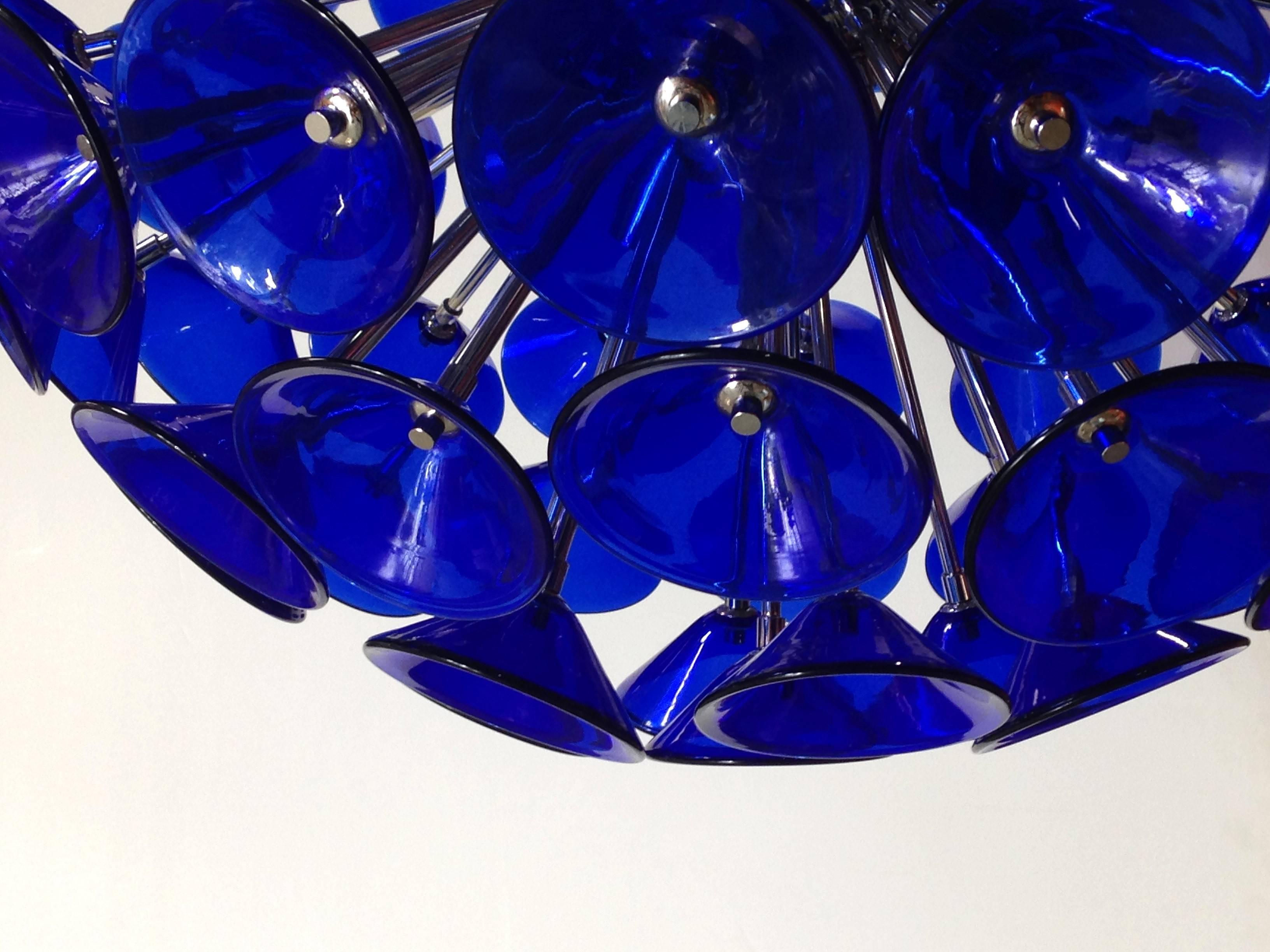 Vintage blue Murano glass trumpets by Vistosi on new chrome metal finish frame by Fabio Ltd
12 lights / E12 type / max 40W each
Diameter: 29 inches / Height: 29 inches plus chain
One in stock in Palm Springs
Order Reference #: VBTM

