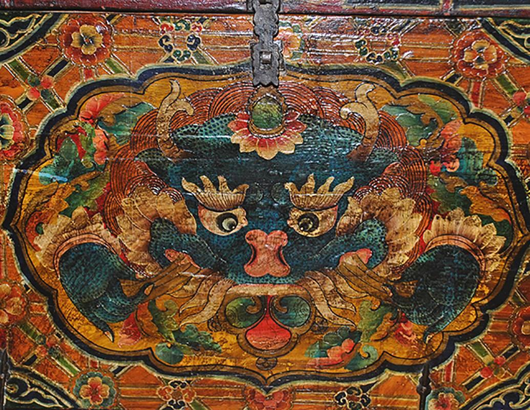 This rare antique hand-painted Tibetan trunk is an intricately painted piece in deep shades of red, jade, black and indigo with Greek key detail and intricate painting. Fitted base (later).