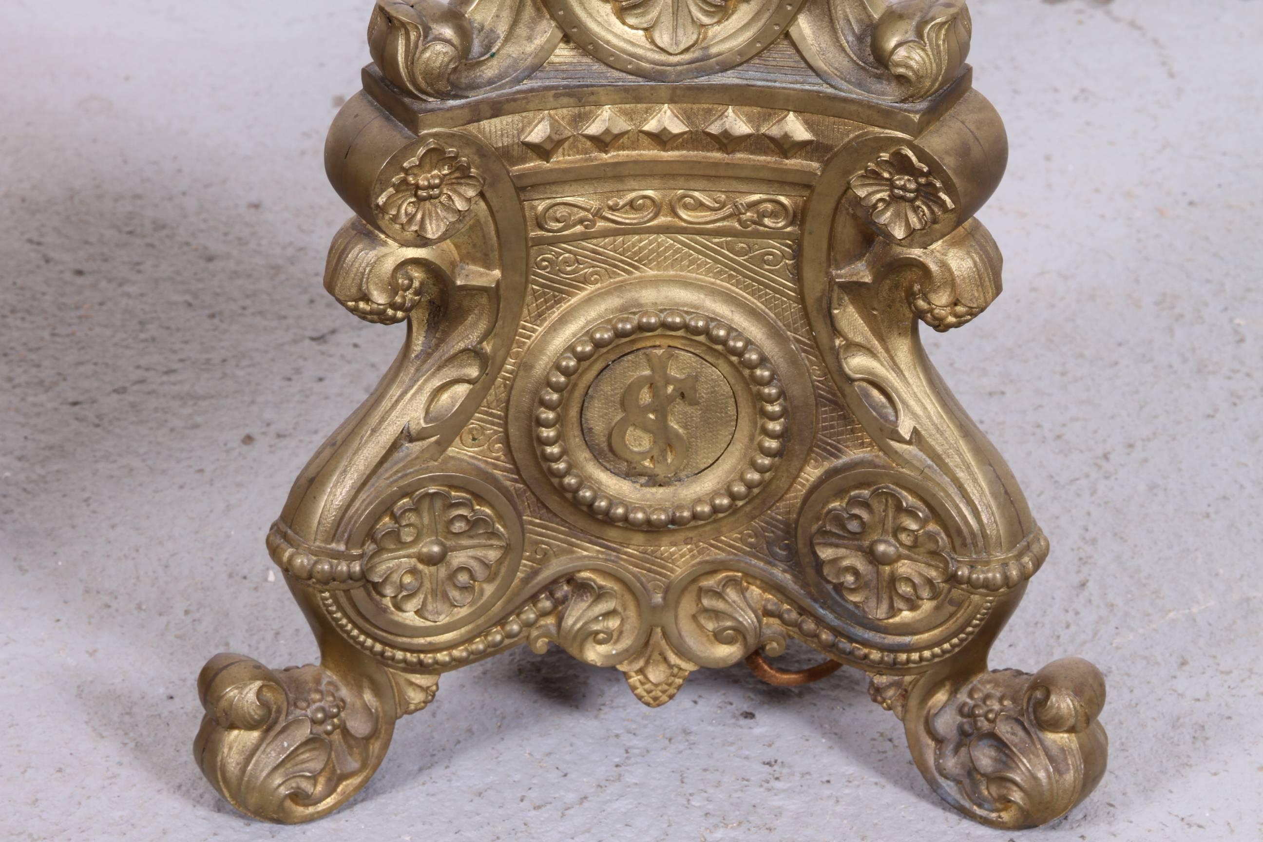 Elaborate pair of antique cast brass altar sticks which were electrified at a later time. Very solid feeling with ornate decoration and each with triple sockets.