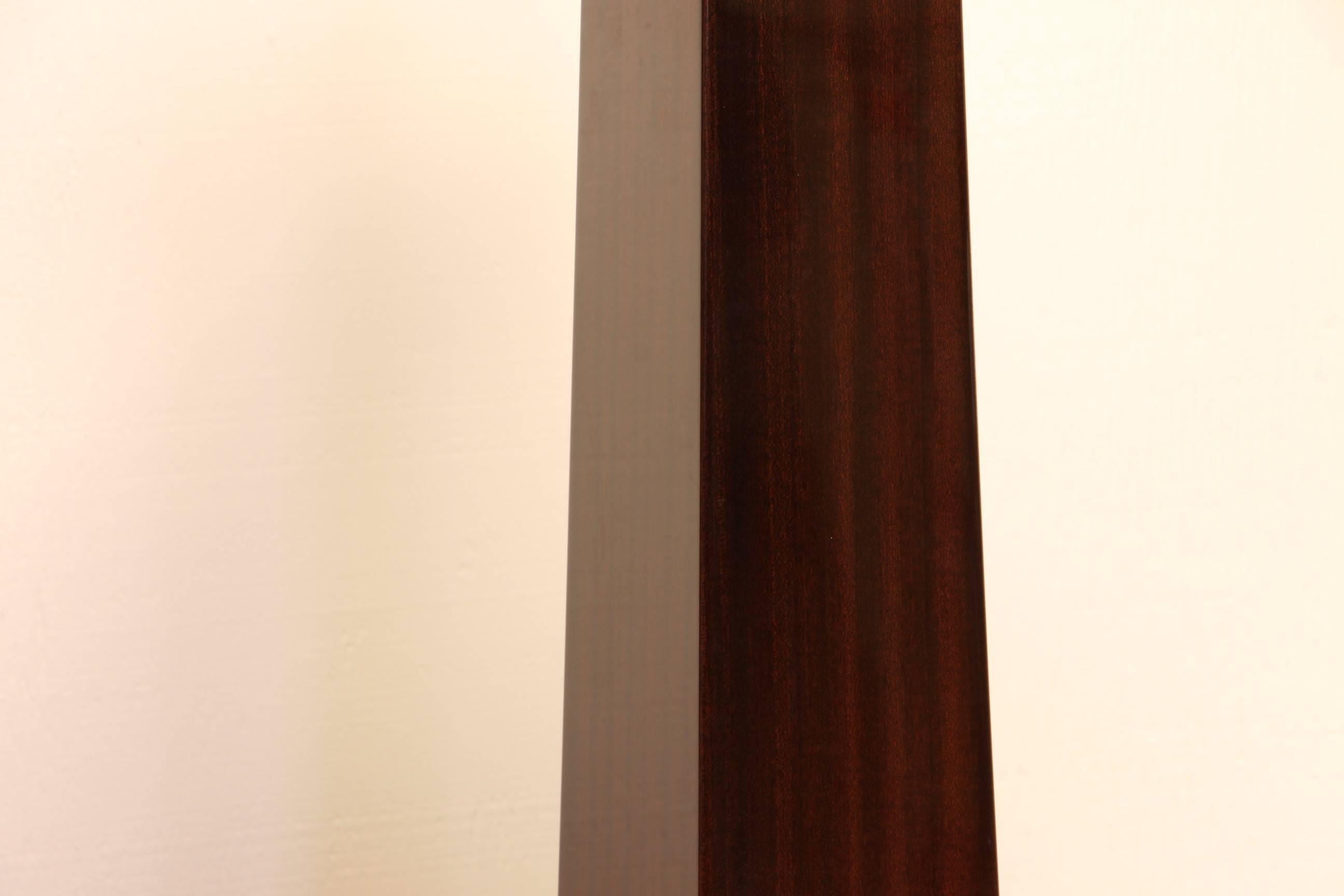 A pair of very good condition Lithic floor lamps designed by Sally Sirkin Lewis and produced by J. Robert Scott. Finely polished mahogany with nickel-plated hardware. The base is 8" by 8".