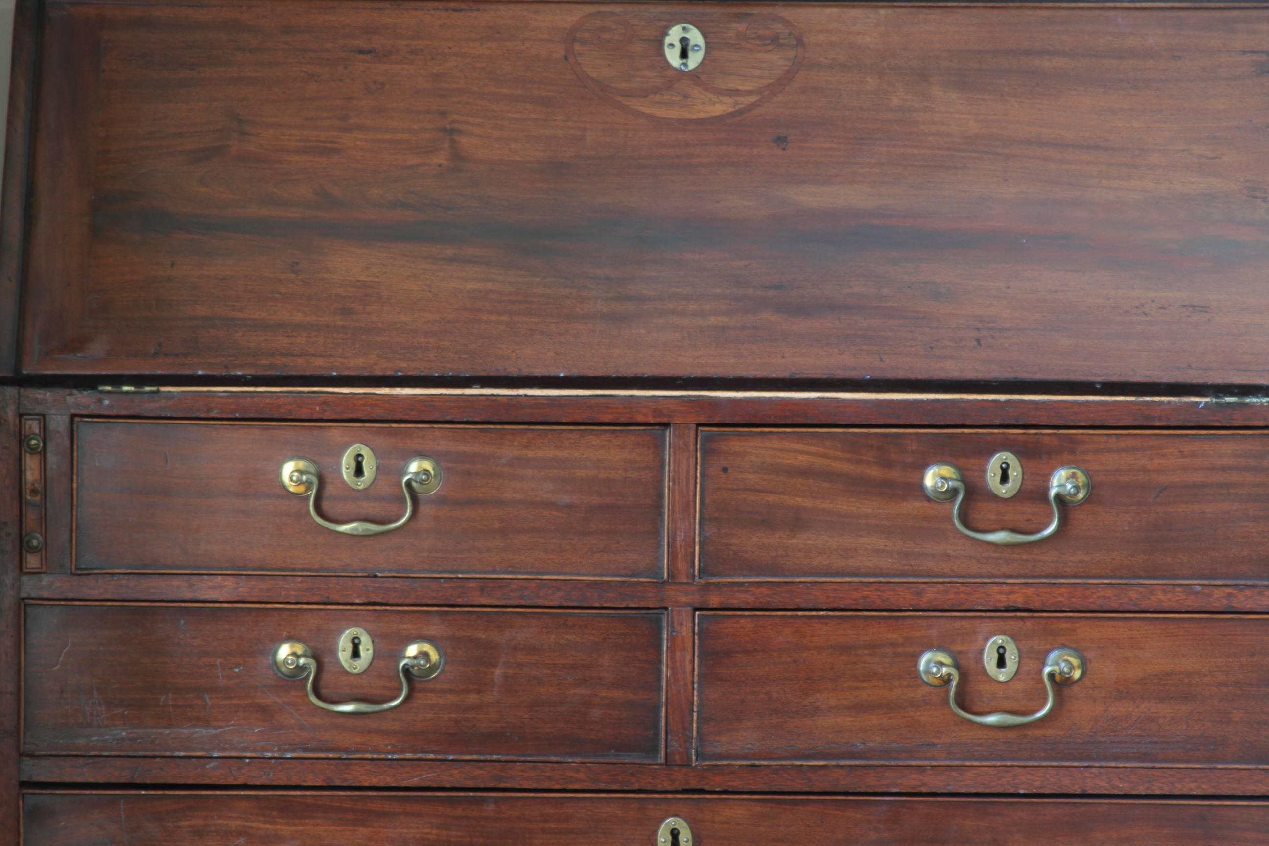 Outstanding late 18th century mahogany secretary bookcase in very good condition. The doors open to reveal three adjustable shelves, 15 various sized drawers, dentil molding, and a green tooled leather writing surface. Base shows two over four