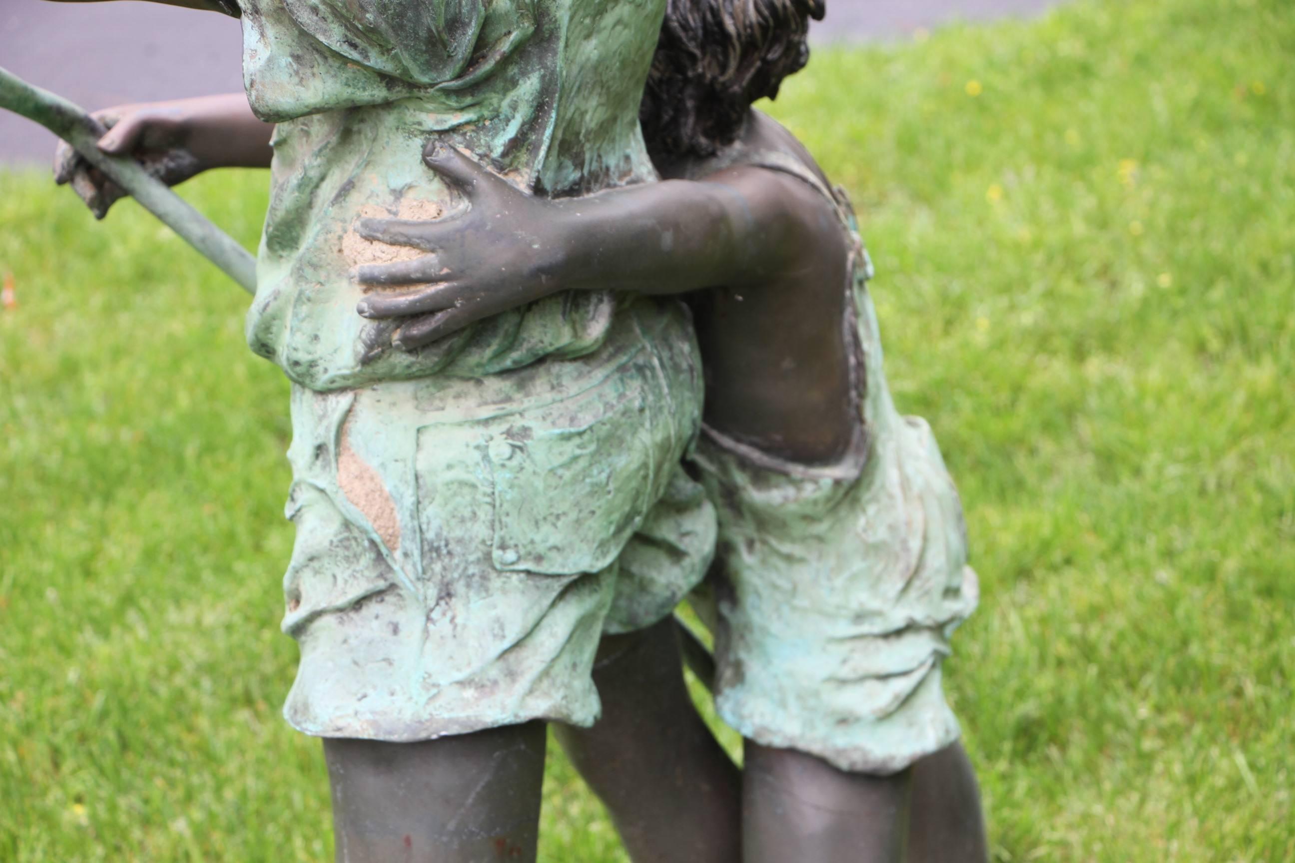 The bronze sculpture of a boy and girl holding the garden hose. Well made and very naturalistic. 
Polychrome patina.
 