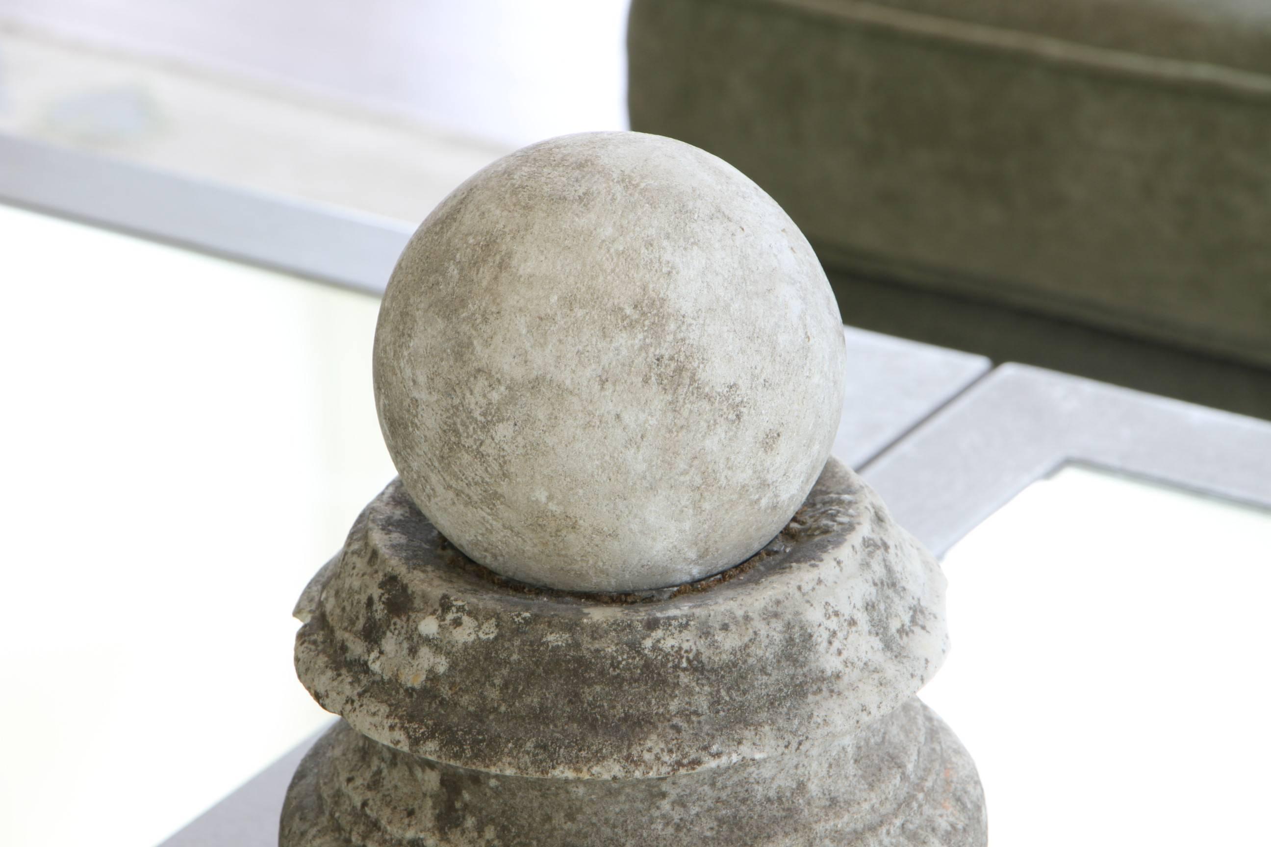 Fine worn urn and sphere on plinth base. Overall great age patina, including two chips under the urn's rim.