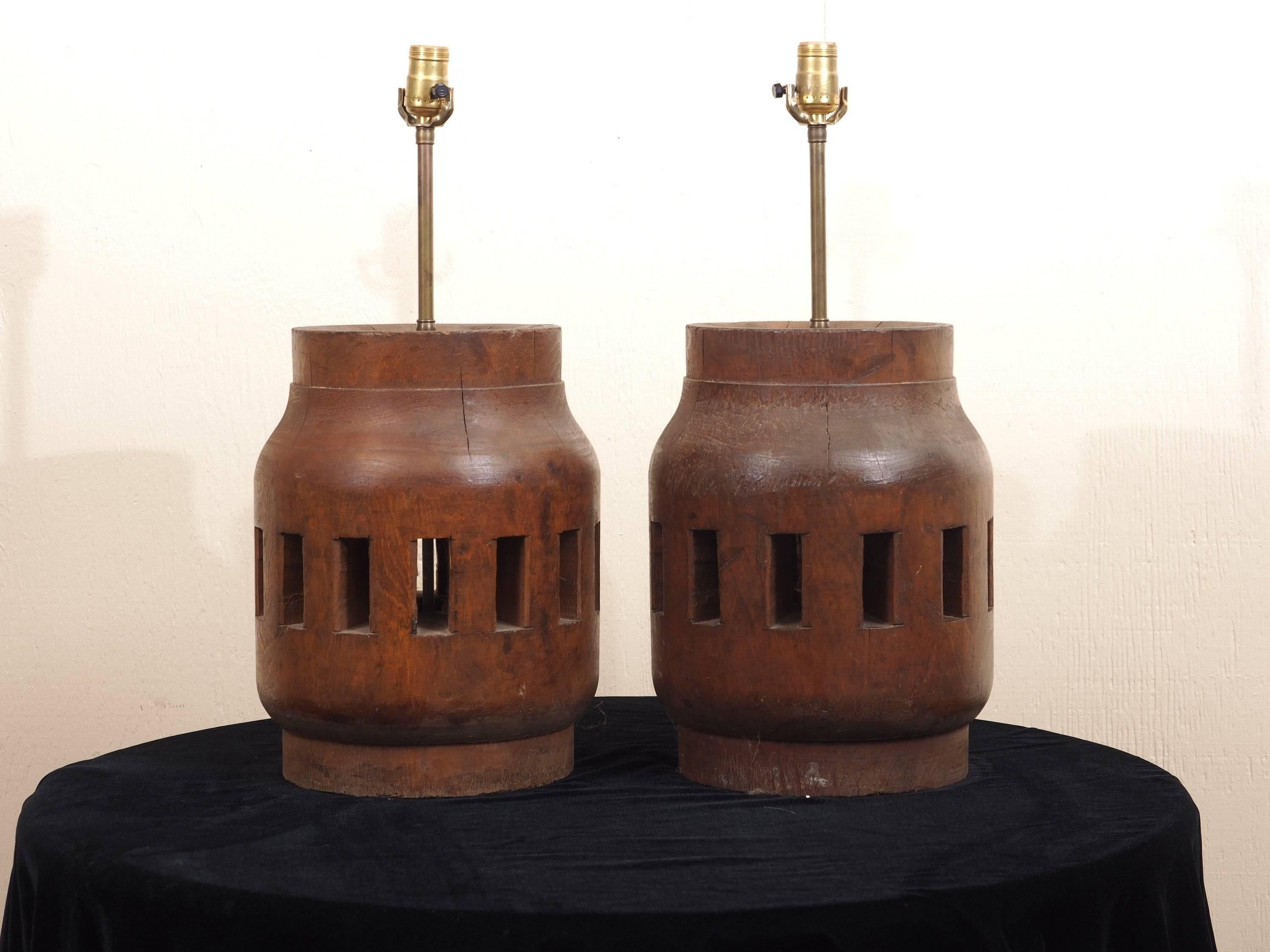 Antique wood barrel wheel hubs with elemental form and good weight, converted to lamps. Excellent age and use patina. There is some age appropriate splitting to the wood which does not detract.

 