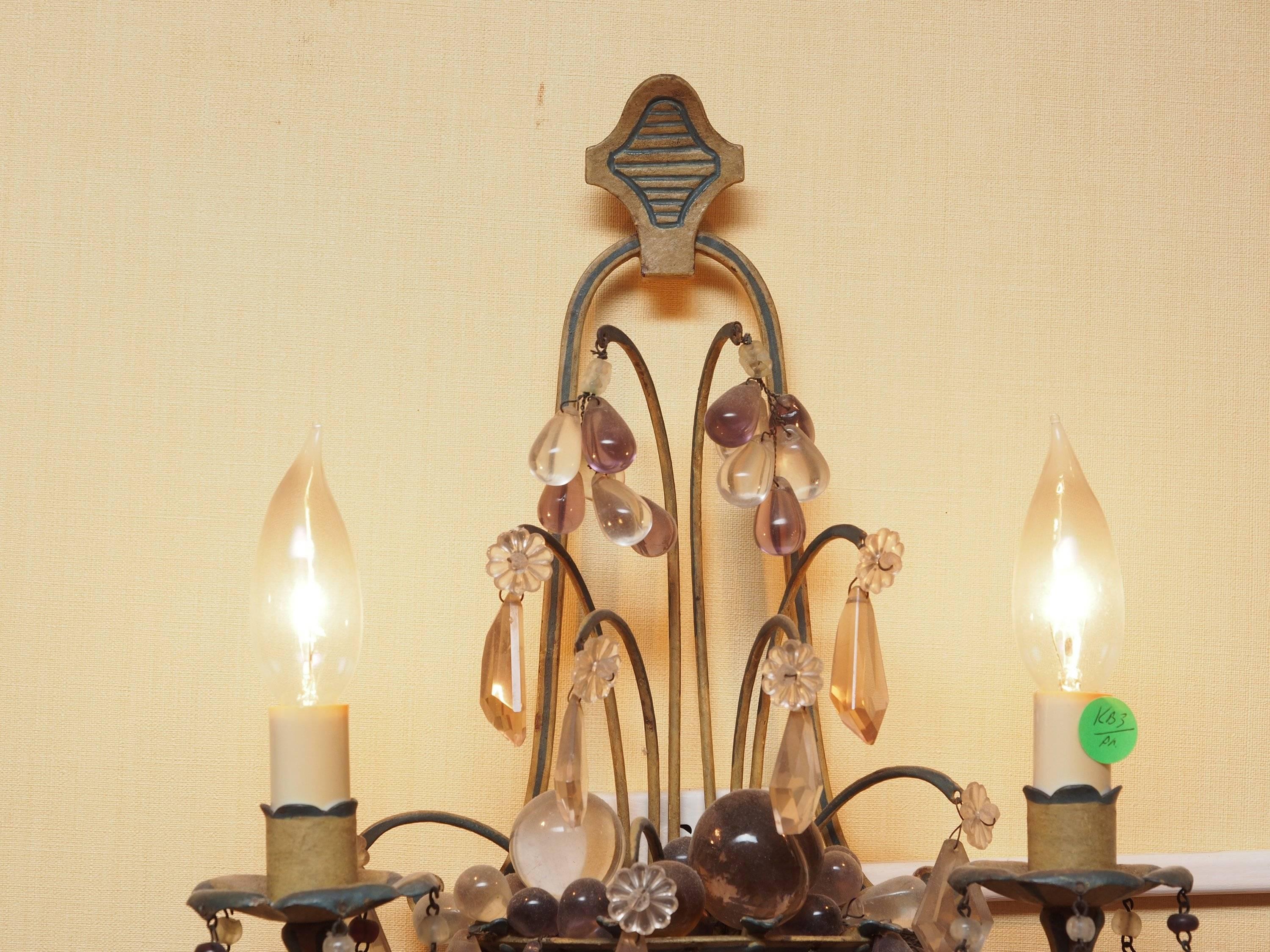 Pair of stunning two-light antique flower basket form, crystal and bead encrusted with paint decoration wall sconces. The metal woven baskets are decorated with clear, amber and amethyst beads and crystal prisms. Measures: 16