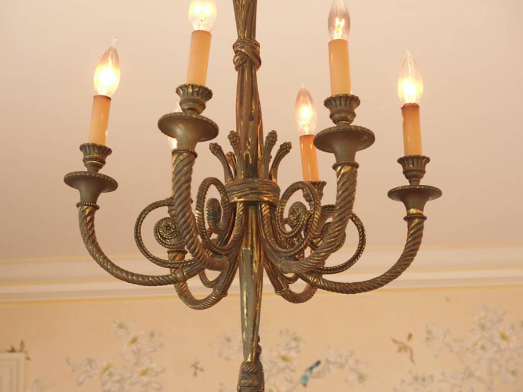 Six-light bronze chandelier with rope form arms and loops tie top terminating in a tassel. Condition consistent with age and use.