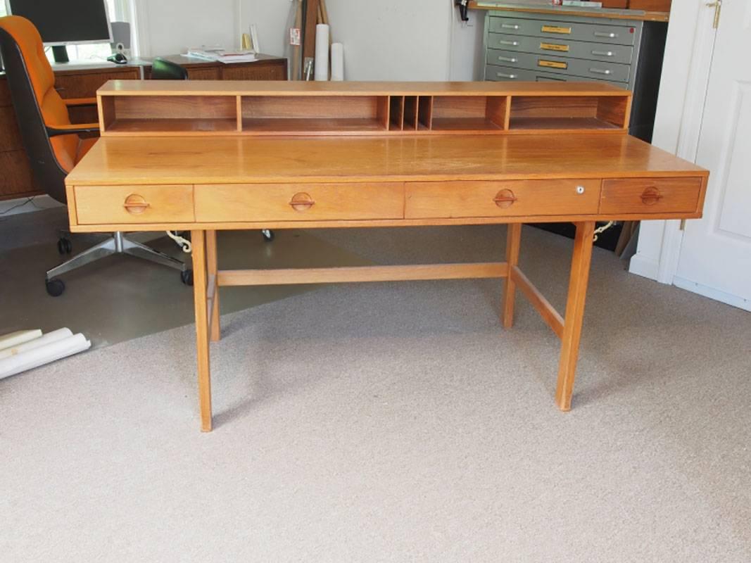 Classic Mid-Century desk/table with flip-down section which creates larger surface for blue prints or dining. Designed by Peter Lovig Nielsen. Very good all original condition with acceptable wear. Desk height is 29
