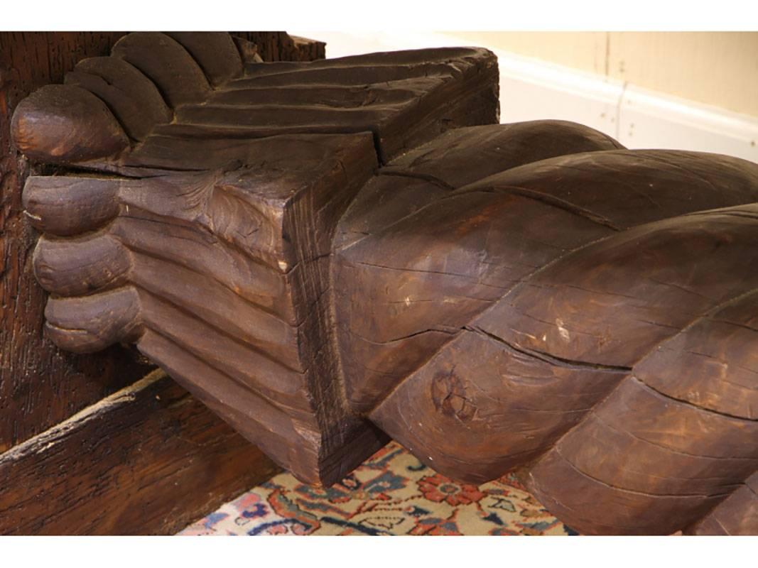 A massive distressed trestle table with deeply carved center top, covered with glass, having a 9