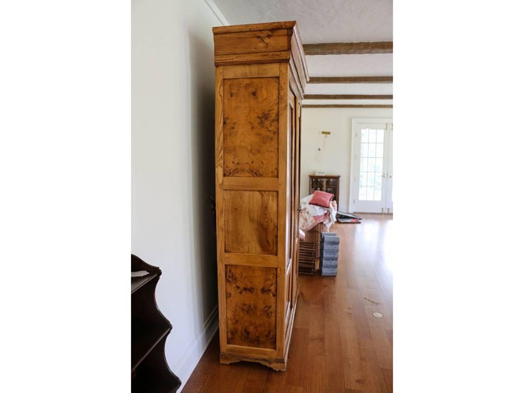 In very good condition with nicely figured elm and stately proportions. Gathered red plaid fabric behind glass windows on doors. Etched white metal hardware, and blocked feet with crown upper molding. Fitted with four adjustable shelves. Back has