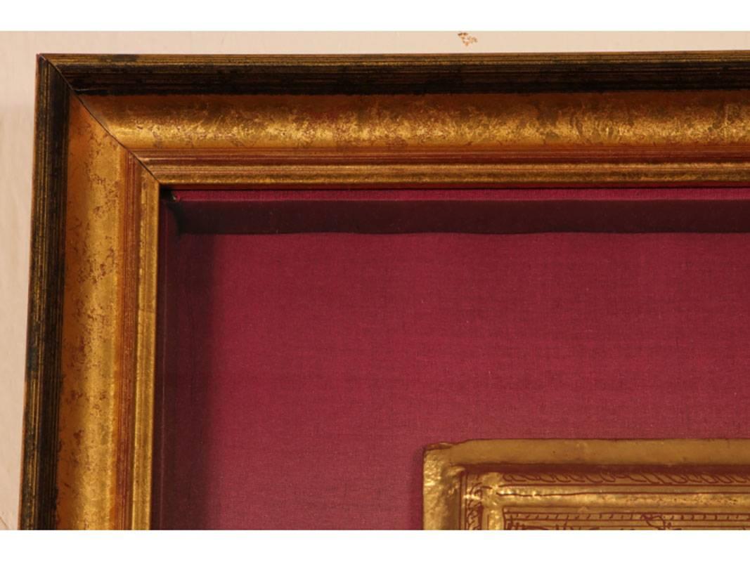 Comprised of eight gilt and red lacquered scripted panels including seven pages with cover; all mounted in a custom shadowbox frame. Very good condition.