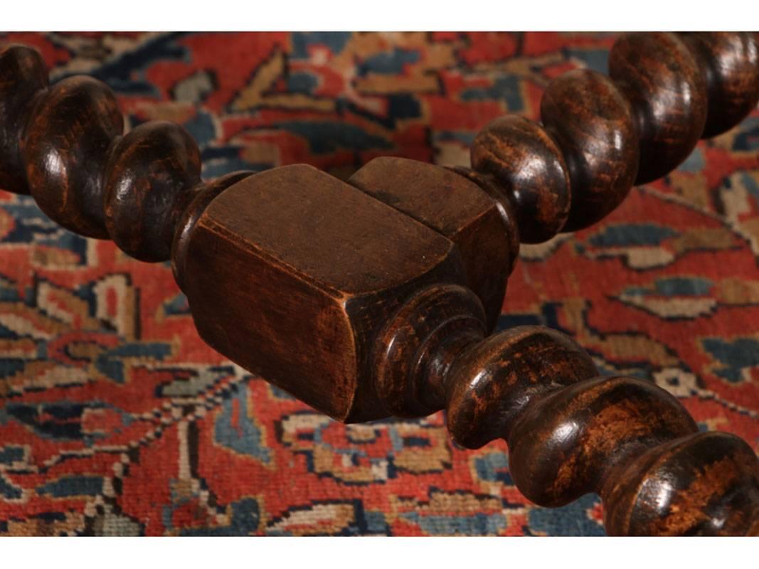 Set of ten upholstered dining chairs with brass tack decoration, barley twist front legs and stretcher. Back legs are squared. Upholstery is in excellent condition in a striped red, green gold and cream high quality fabric. Wood frame has dark stain
