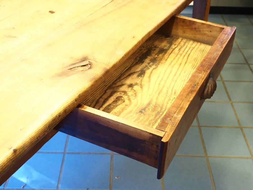 A great classic solid cherry farm table with single dove tailed drawer with bin pull. Legs are squared and slightly tapered. Age appropriate wear and a soft overall hand.