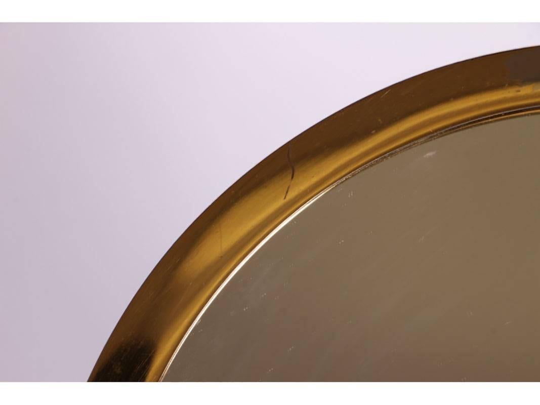 A rare Mid-Century vanity top mirror in brass and polished nickel by designer Karl Springer. Overall in very good condition. Mirror diameter: 8 1/2