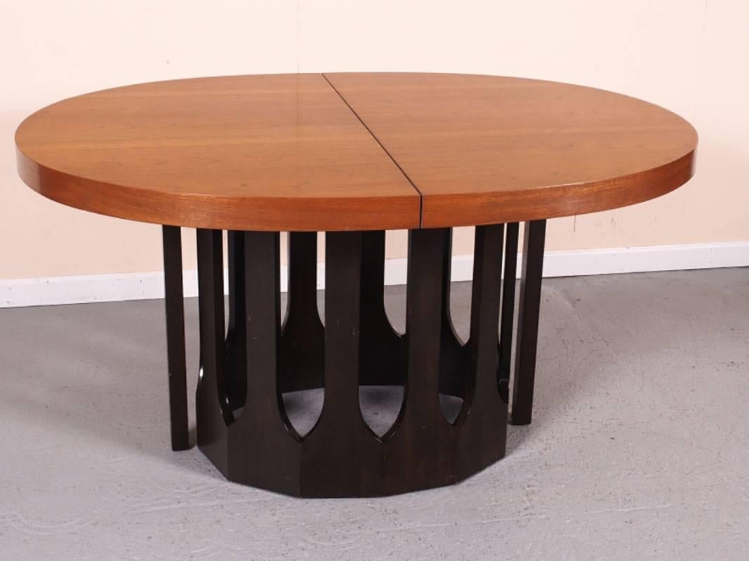 Beautiful rosewood racetrack oval dining table with Gothic arched base. Table comes with three 16" leaves. When fully extended the table measures 104" long. Table and leaves are in very good condition with very slight acceptable age and