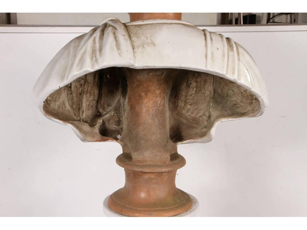 Robe has draped left shoulder, right shoulder has acanthus leaf trim and a medal. Formed with great attention to detail. Pedestal has stabled cracks and repairs to the base. We have found the bust to be very effective when used on a table without