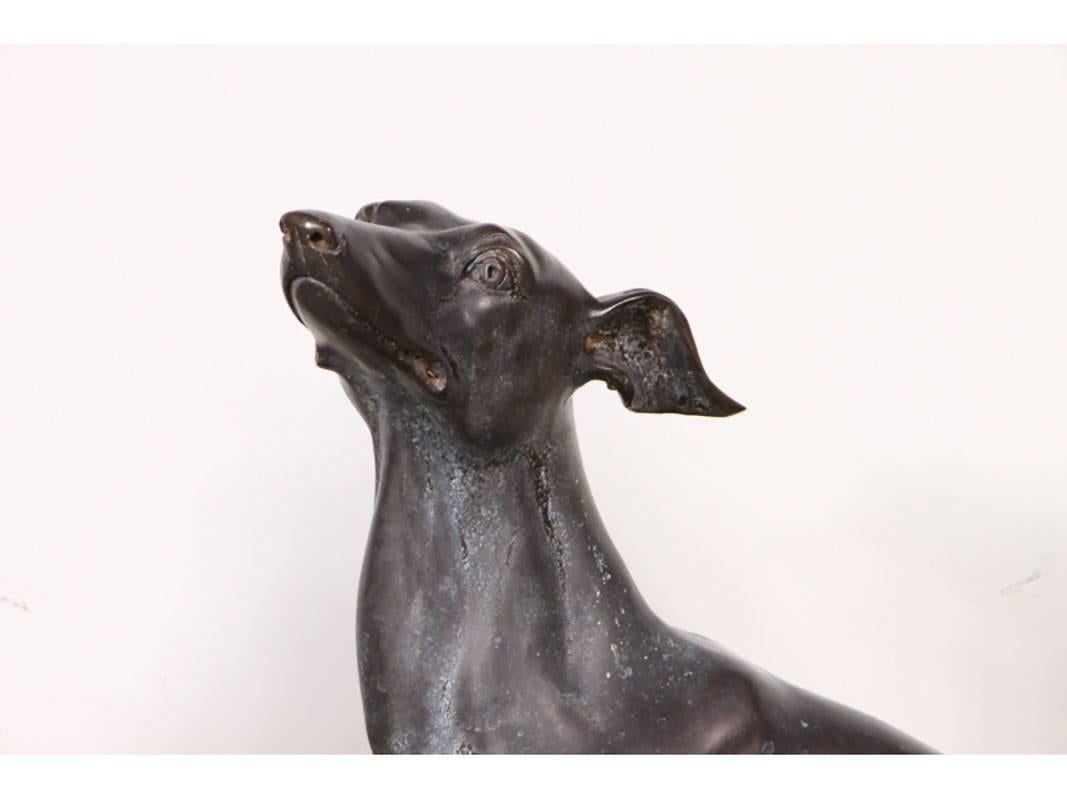 Pair of bronze whippet dog figures, one standing and one sitting.
Very graceful with good age patina consistent with age.
