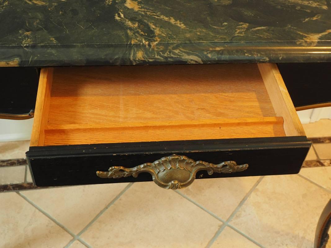 Very well made with all wood construction, well done faux stone top and excellent proportions. Slight cabriole leg with bronze mounts. Single drawer with shell drawer pull. Gilded detail around apron and legs.
Condition some surface marks on legs