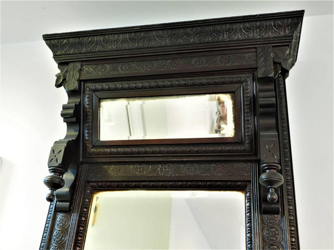 In very good condition with two-part beveled mirror and two built-in candle stands.