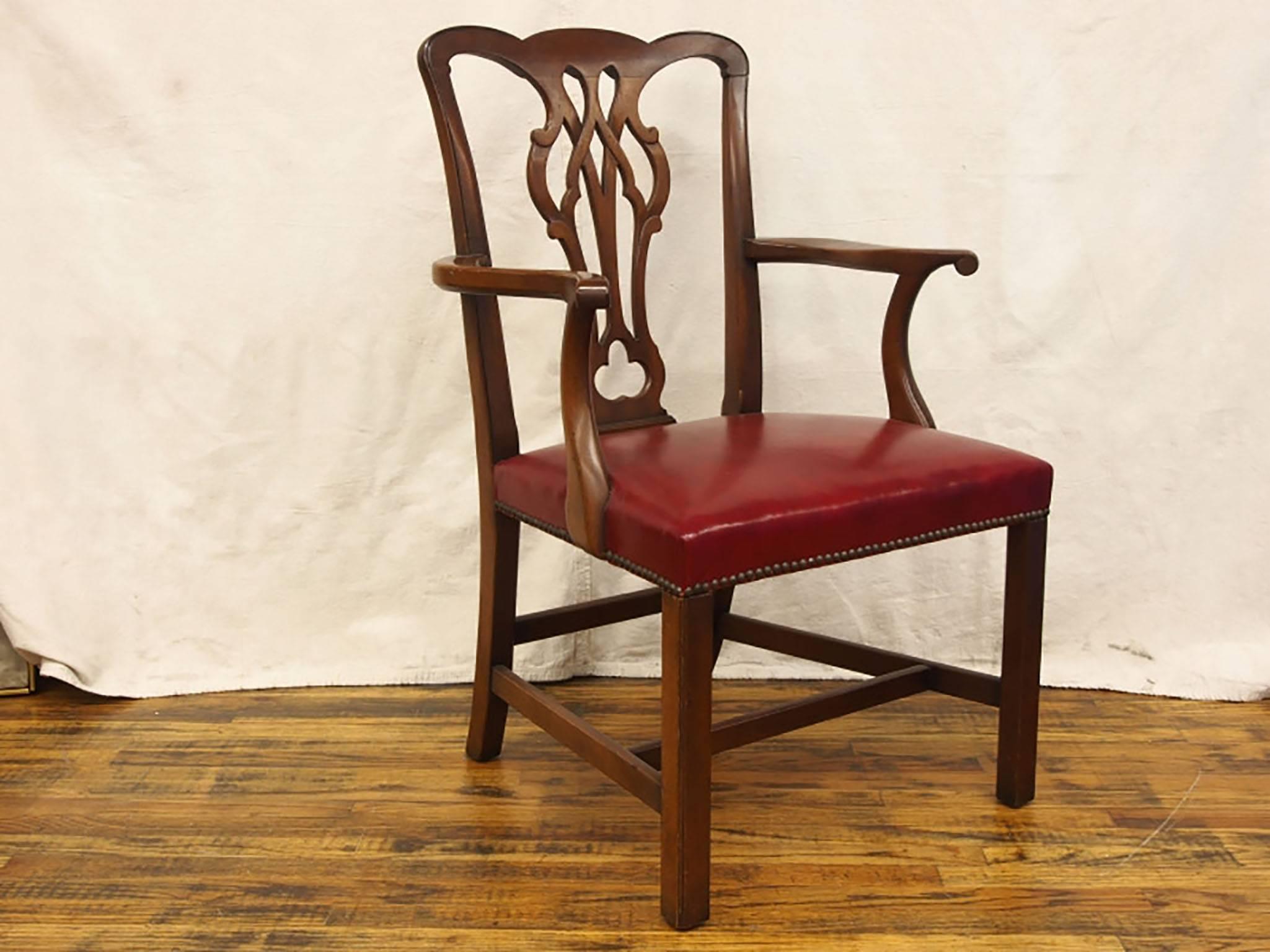 An outstanding set of Mid-Century English style solid mahogany frame dining chairs in very good condition, made by Kittinger. The seats retain their original vibrant red glazed leather style vinyl seats and have brass nailhead trim surround. Two