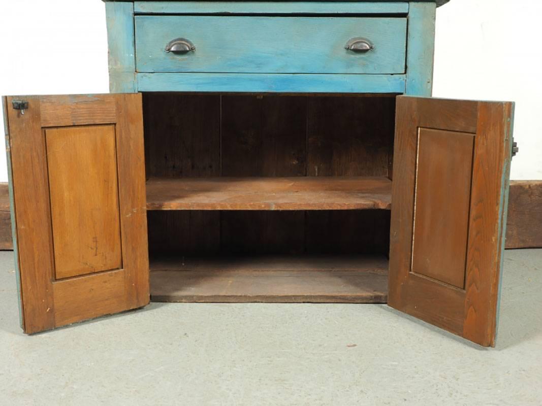 Paint decorated cupboard in two parts. Top with planked back and open shelving. Lower cabinet with cup drawer pulls, latch, single drawer and cabinet doors revealing shelving.
Condition: consistent with age and use.