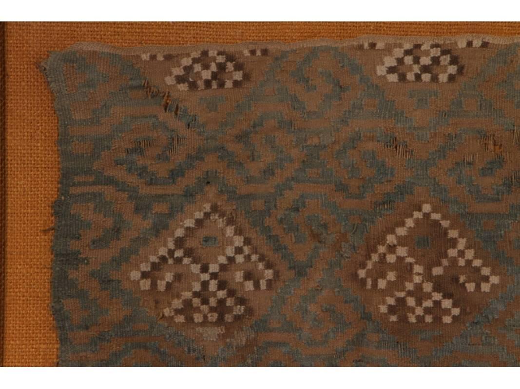 Peruvian Inca textile fragment mounted on burlap in a gilt frame.
Fragment measures 13.5
