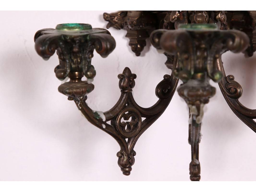Wall sconces having three candle lights with pierced architectural design. Not electrified. Can be used anywhere.
Condition: Wax residue from usage.