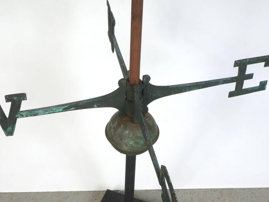 Vintage green patinated copper schooner weathervane with iron directionals and mounted on a custom base.
Condition: Consistent with age, nicely patinated.