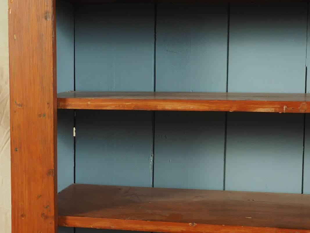 Late 19th-early 20th century American pine cupboard with paint decorated interior upper shelves. Original embossed iron bin drawer pulls. General age or use acceptable wear.