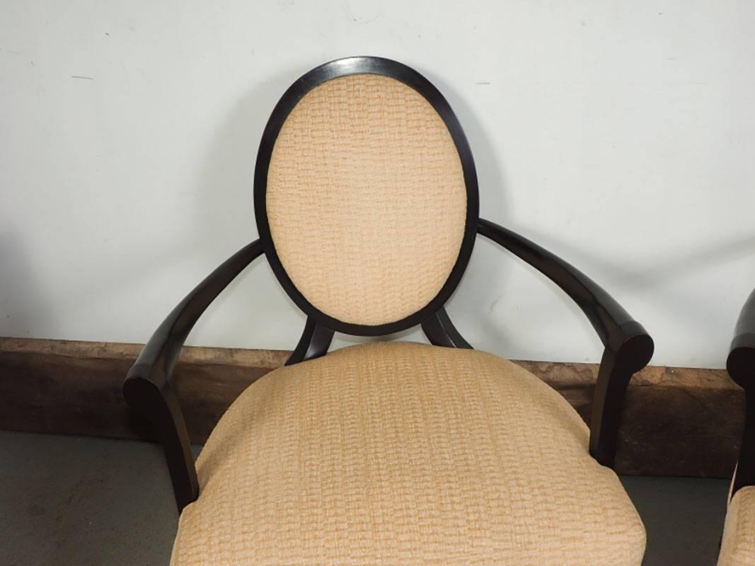 A twist on a French neoclassic form. Oval X-splat to the back and fully upholstered to the front. Exposed wood frame with flaring arms and tapered legs. This chair converges to a focal point at the oval back.
Neutral upholstery with java (deep rich