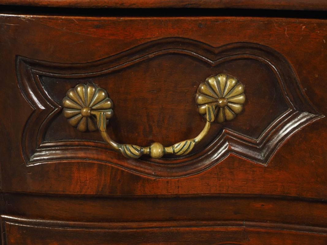Classic French chest in very good condition with great proportions, fine finish and perfect form. Cabriole leg, scalloped apron with shell crest, fluted corners, unique brass hardware.