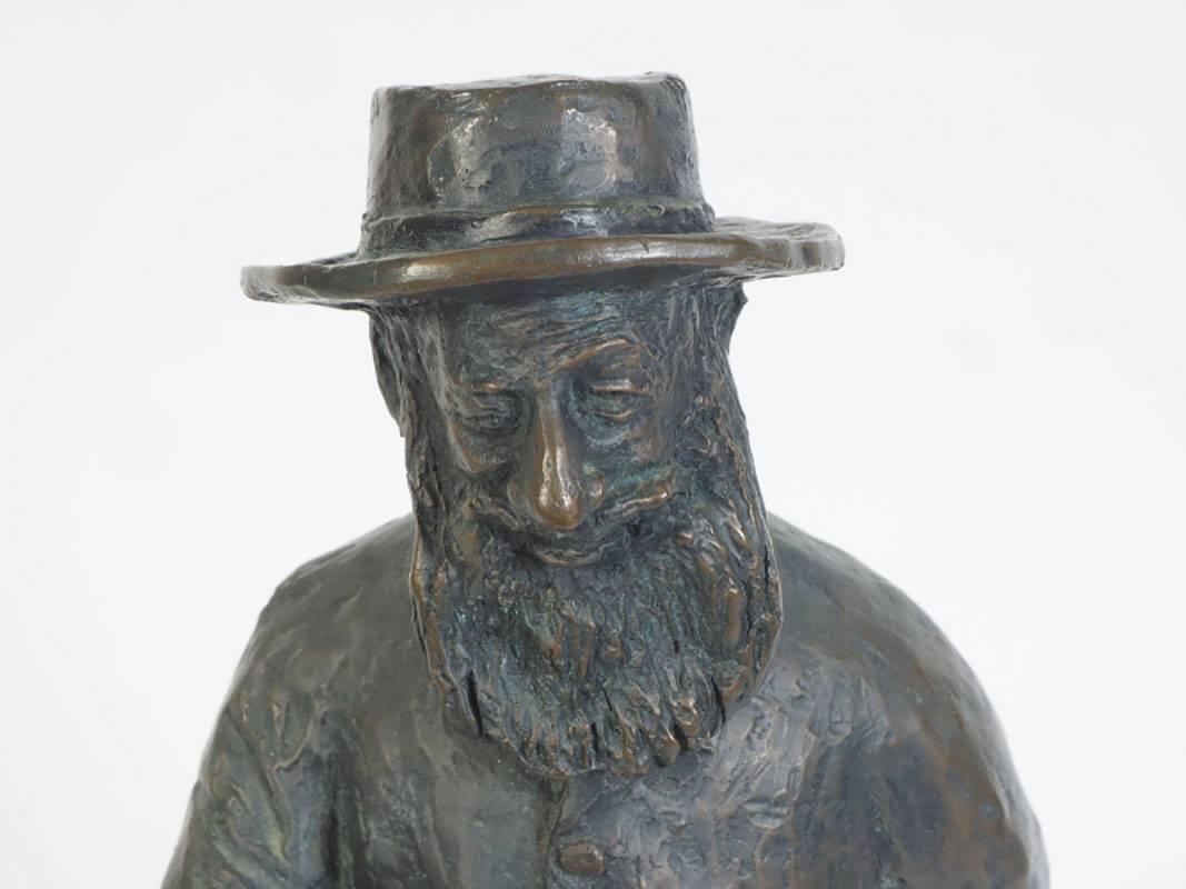 Bronze sculpture of a bearded Judaic figure engrossed in conversation and gesturing with his hand to make a point.
Signed on back of base.
Condition: Good.