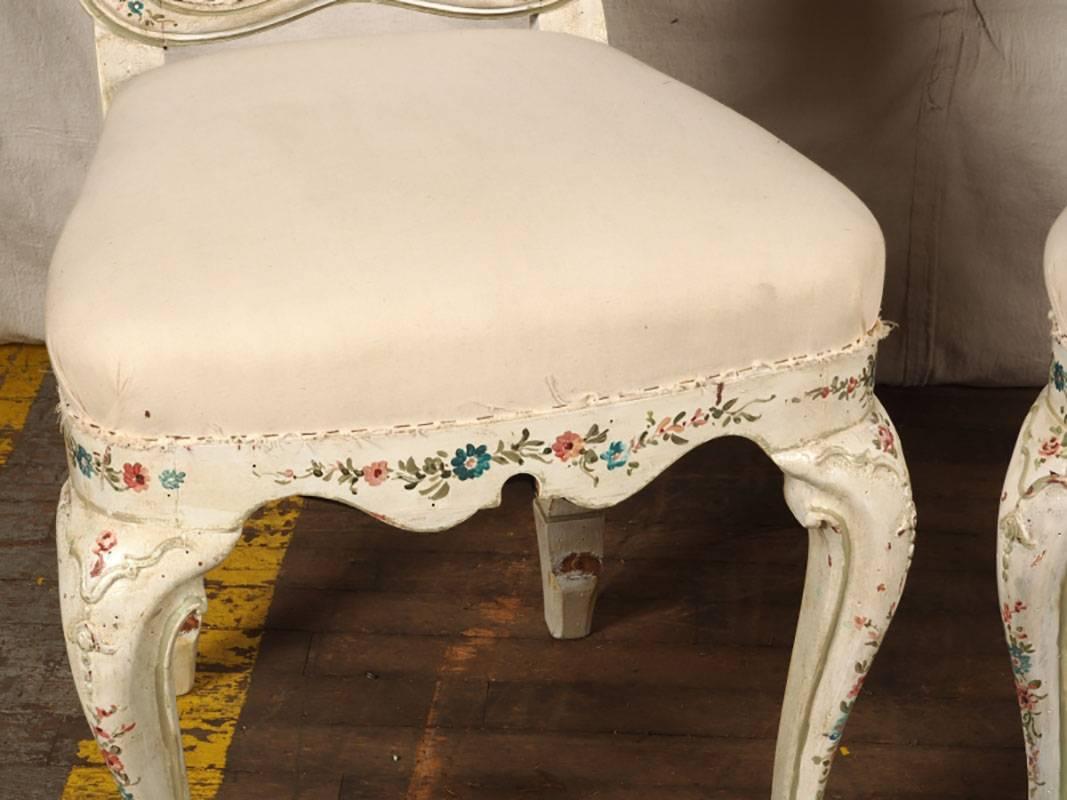 With good weight and a fantastic worn and lovely style. Chairs have polychrome floral painted details. Three of the frames need tightening, and the fabric needs to be replaced as the muslin has wear and some stains. Despite the wear, this is a truly