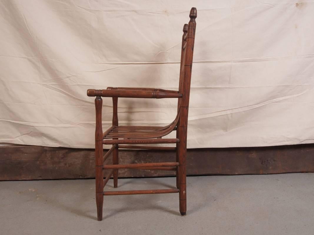 Vintage bentwood chair with slat construction, double stretcher, turned arms and finals. Good condition commensurate with age.