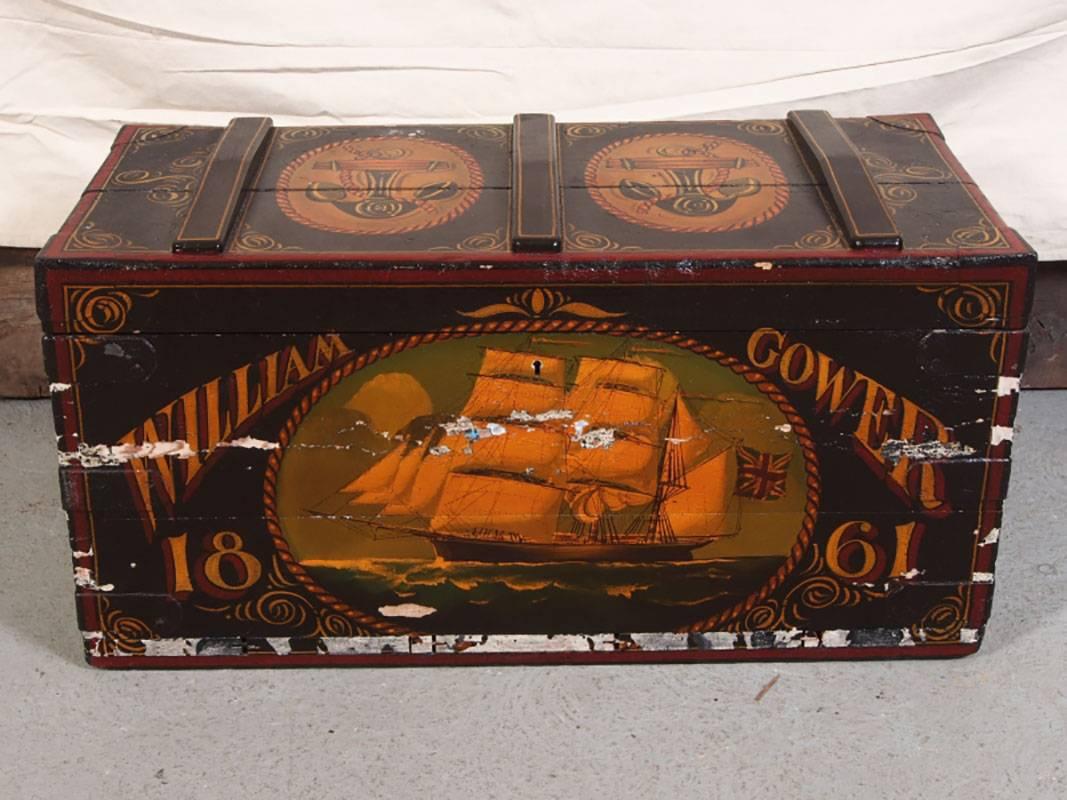 Antique sailor's sea chest in later nautical paint decoration. The chest has planked construction, wooden side handles with hook opening. Later paint decorated with large masked ship inside a rope trimmed cameo, with the name William Gower and dated
