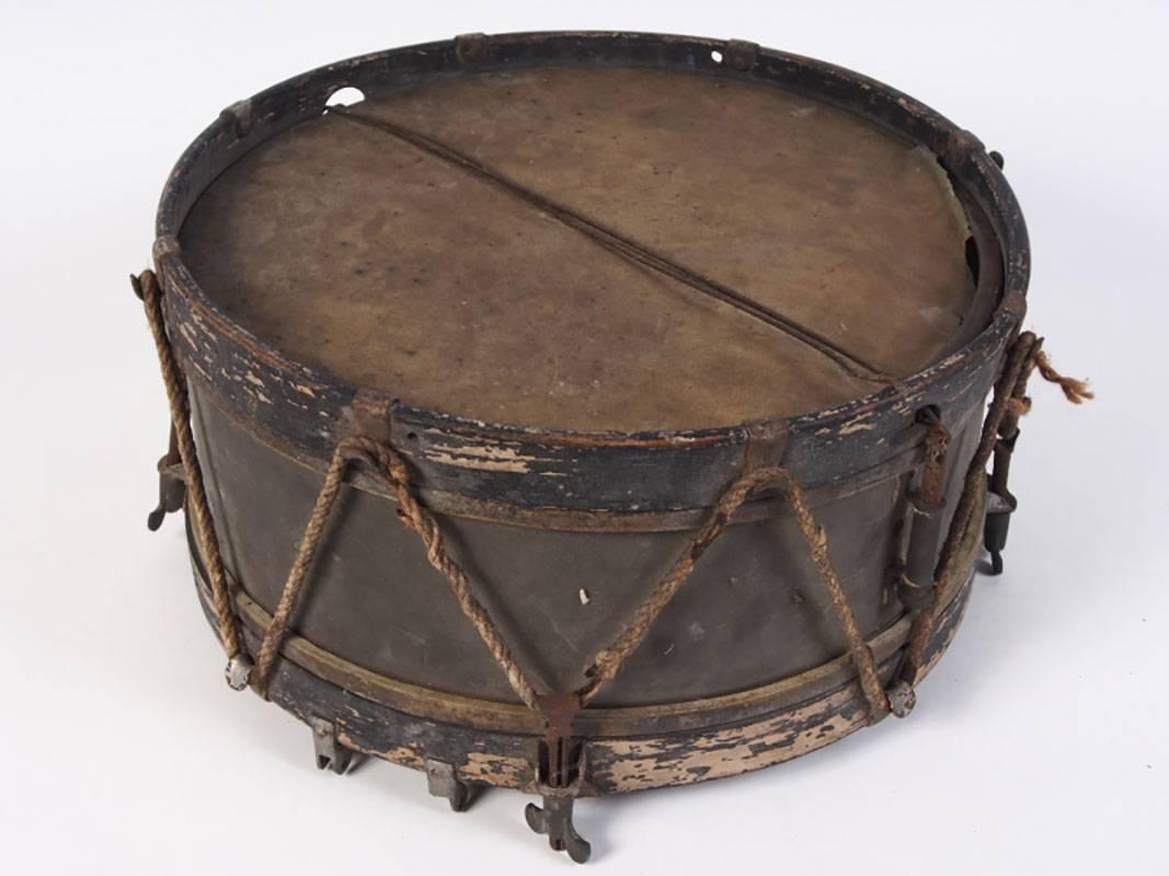 Antique French toy drum, circa 1890, with original old black paint and ropes.
Measurements below do not include hardware. 
Condition: flaking to painted frame, tear to one side of drum, rust to hardware consistent with age.