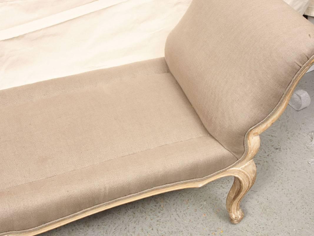 Bench having rolled arms, scalloped apron, cabriole fluted legs. Nicely upholstered in natural fabric. In good condition.