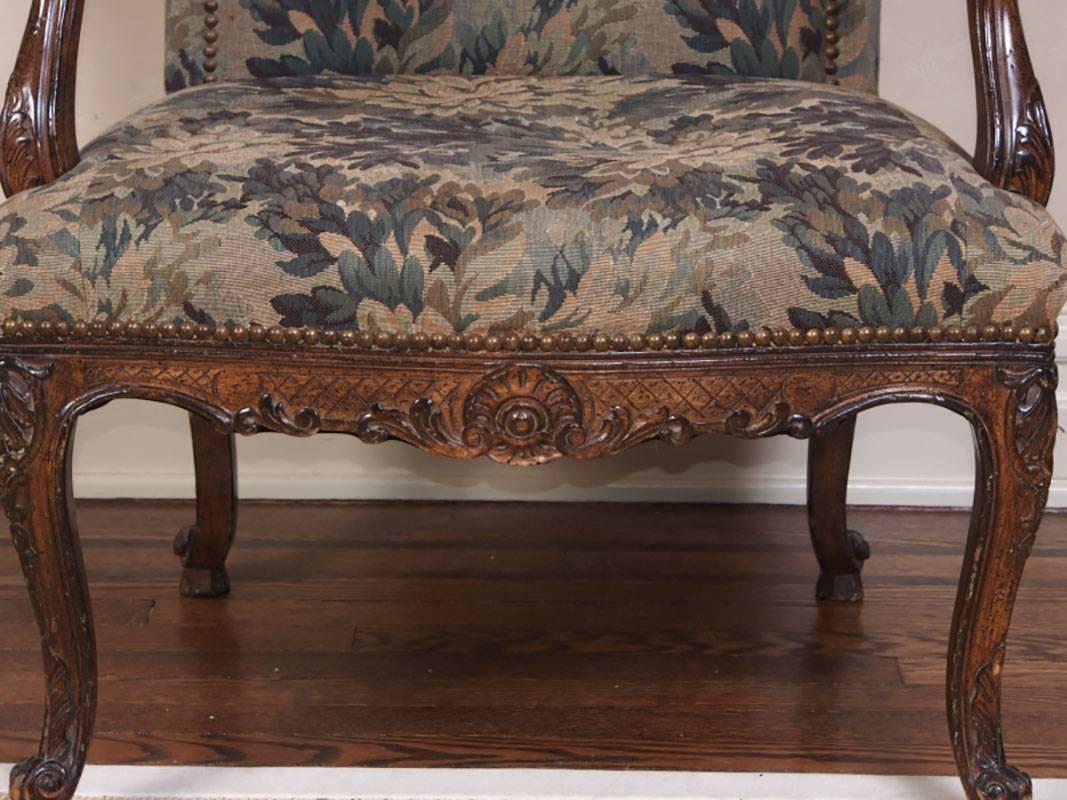 Tapestry upholstered fauteuil with well carved frame, brass tack decoration.
Condition: wear to upholstery at corners; otherwise light wear to frame consistent with age and use.