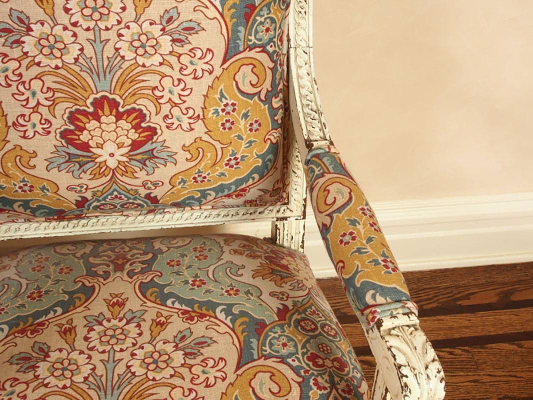 Pair of recently upholstered Pierre Deux fauteuils, paint decorated and distressed frames, foliate carved design, fluted legs and raised on turnip feet.
Condition: Good.