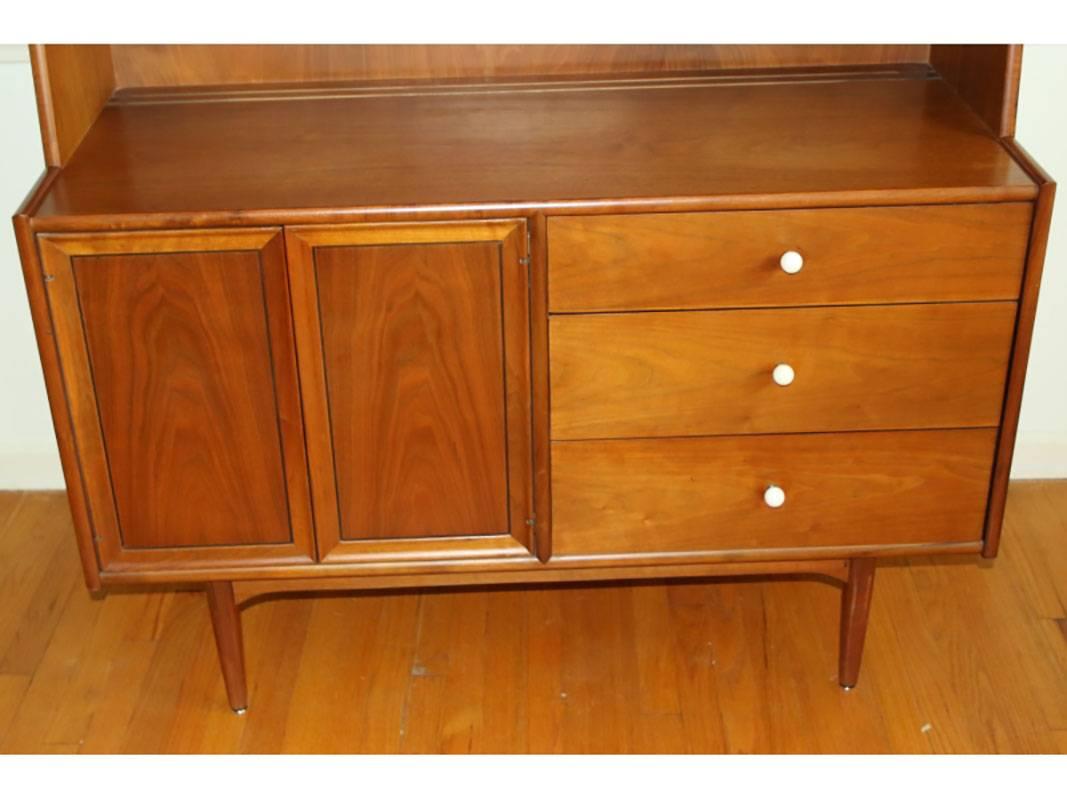 Walnut with sliding glass doors, fitted with a bank of drawers with original porcelain knobs nest to a storage cabinet.
Good condition.
 