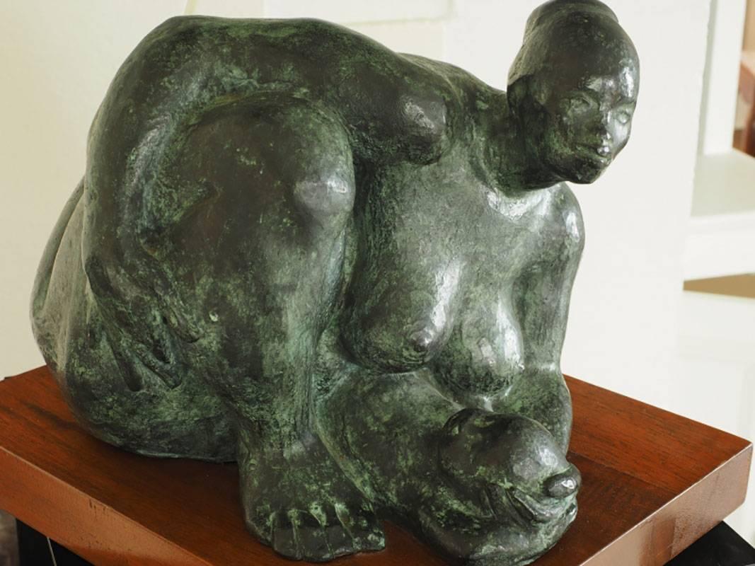 Green patinated bronze of a mother and child mounted on a wood plinth base. Signed on verso as shown.
Condition: Light loss and dents to wood.

 