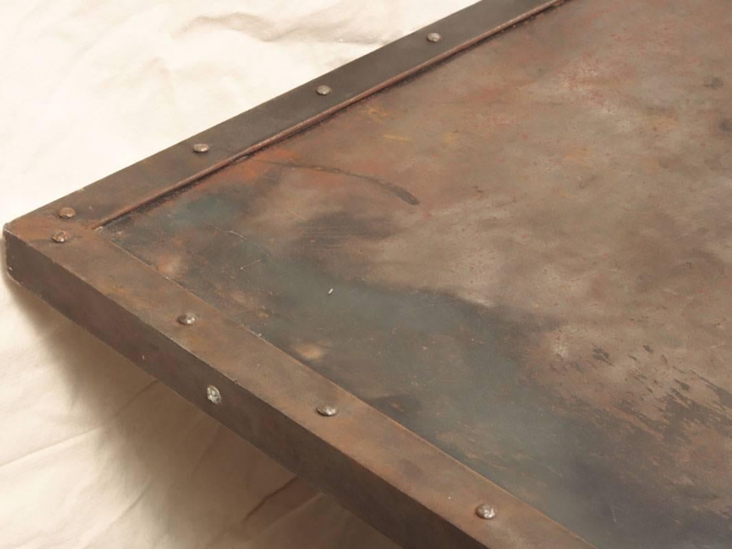 Great Industrial transformation of a steel door into an outstanding dining table. Rustic patina and rivet decorated. Suitable for desk or dining.
Condition: Rustic and patinated with an Industrial feel.
 