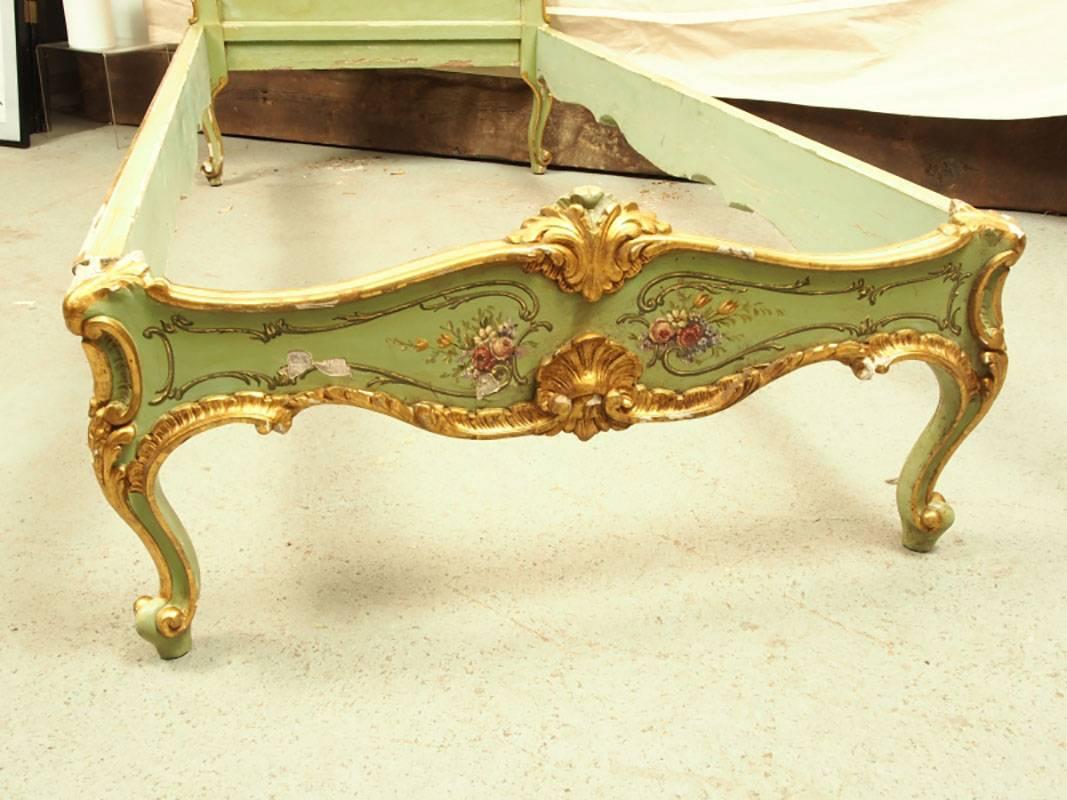 An antique Venetian carved gilt and paint decorated bedstead with silk button tack decorated head-board. The pieces are hand-painted and lavishly gilt, proud acanthus leaf crest.
Measurement:
Interior: 34 inches wide and 78 inches long.
Outside: