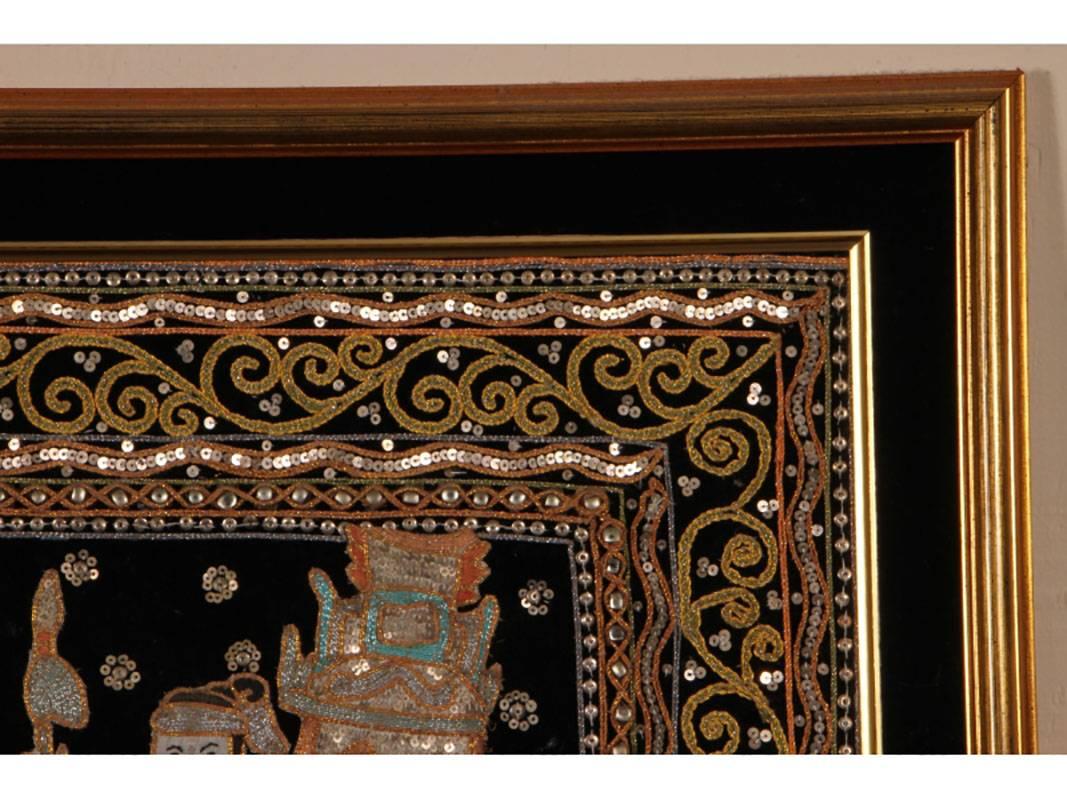 Six warriors rising upon elephants. The border having glass beaded trim. The elephants and riders are down or cotton filled and stand out from the back ground.
Good condition.