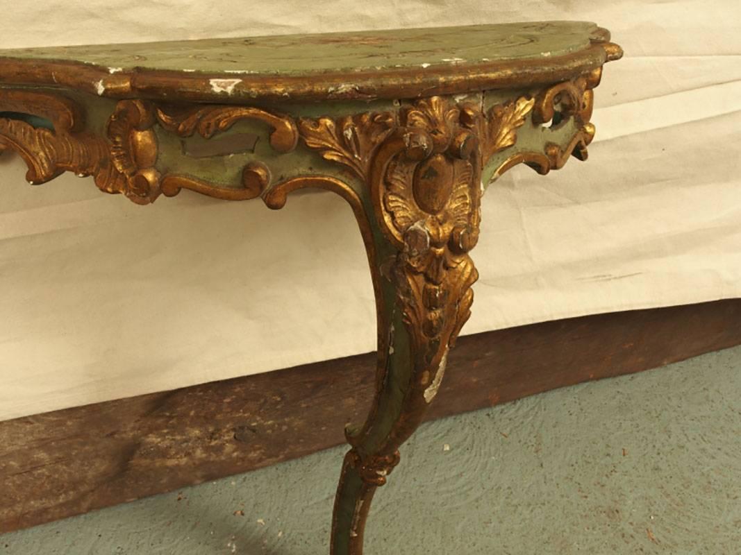 Antique French gilt and paint decorated wall console with embossed gilt decoration, pierced work, acanthus leaves and cartouche. Top with hand-painted bouquet.
Condition: Very distressed, chipped with losses.