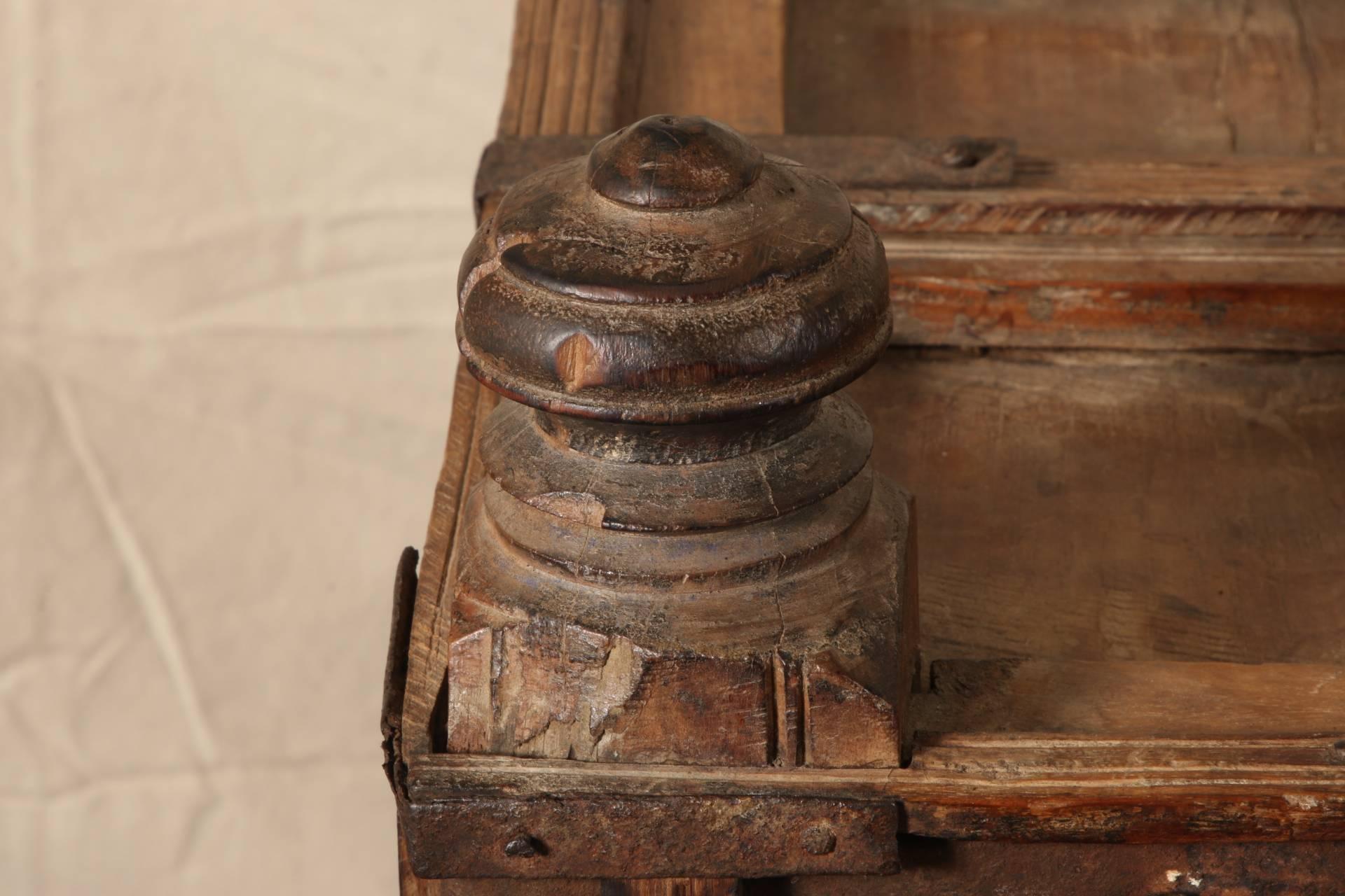 The entire chest with framed square panels in three rows on the top, and four on the front, sides, and back. The front panels have added X form decorative pieces and all frames have brass roundels. The front top band with hammered brass appliques.