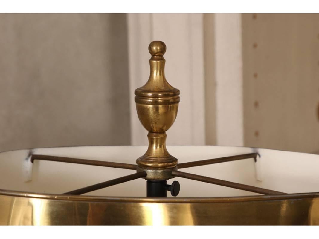 Finely crafted with twin scrolled brass lights and oval scalloped brass shade and brass oval table. The whole raised on an iron barley twist support with tripod legs. With an urn form finial.
Condition: age and use wear to the shade and table.
